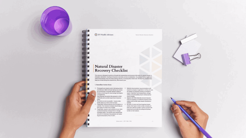 Person reading Natural Disaster Recovery Checklist from JFS Wealth Advisors