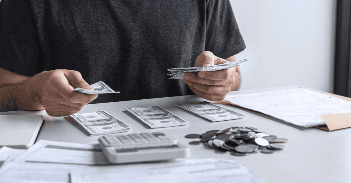 Debt management image, a man budgeting his cash to pay off any debts.